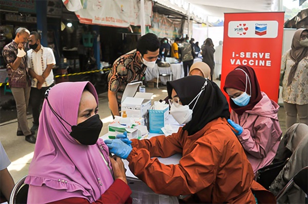 A woman getting vaccinated at one of the i-SERVE vaccine program locations